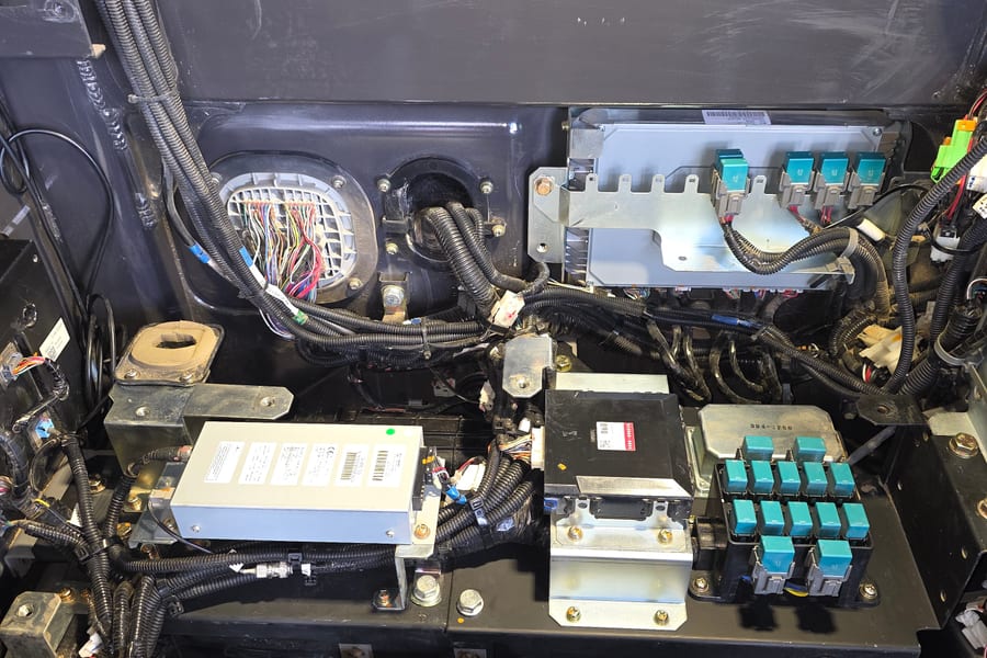 Auto electrician diagnosing wiring on heavy vehicle